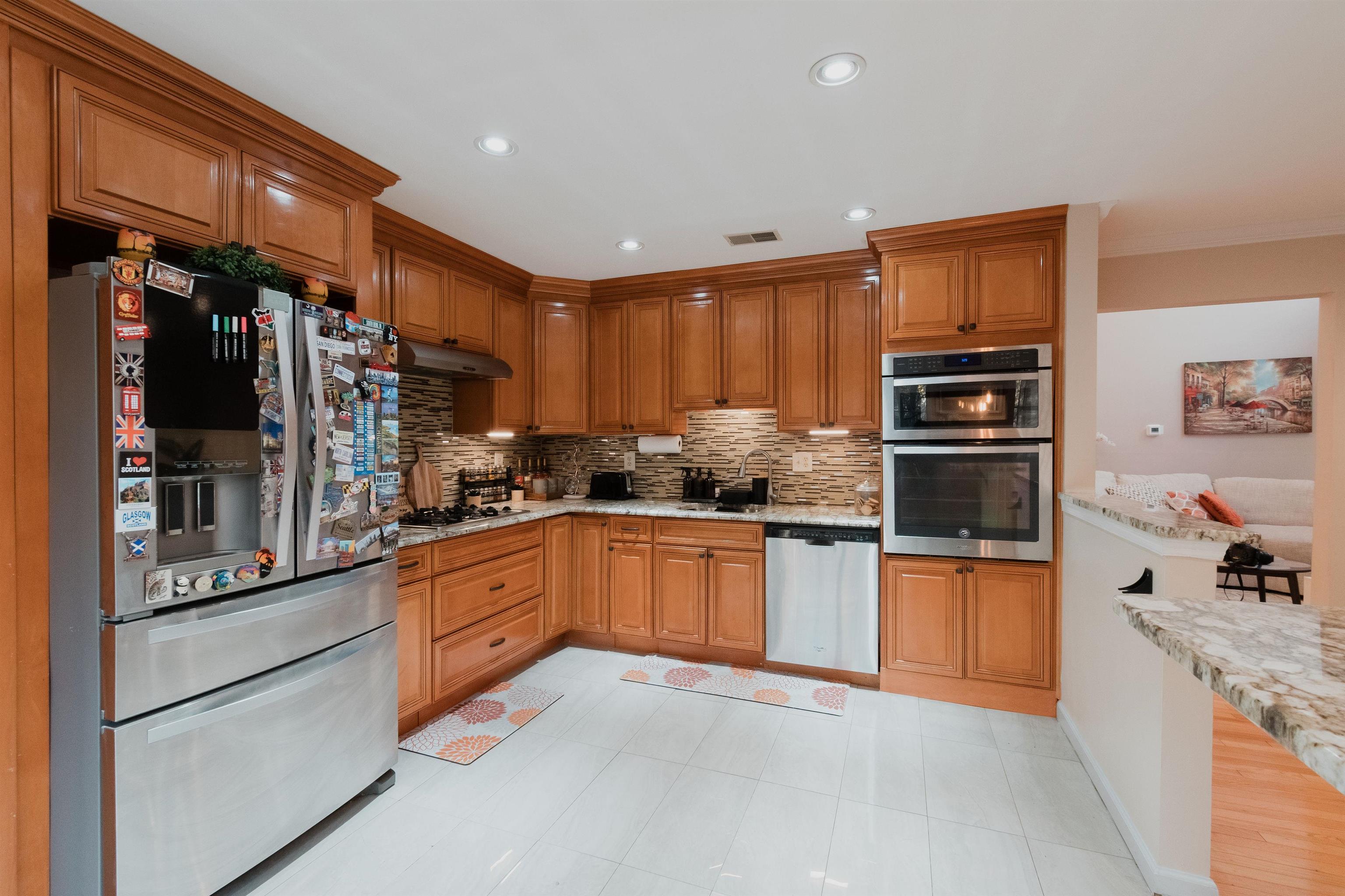 59 Morning Watch Road Wayne, NJ 07470 - Photo 3 of 12 a kitchen with stainless steel appliances granite countertop a refrigerator and a stove top oven