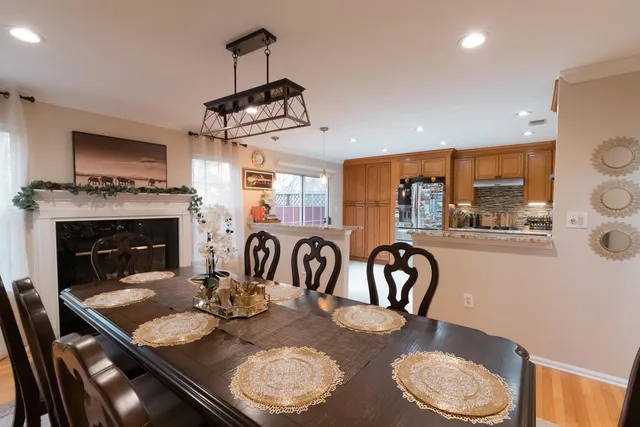 a kitchen with a table chairs and a fireplace