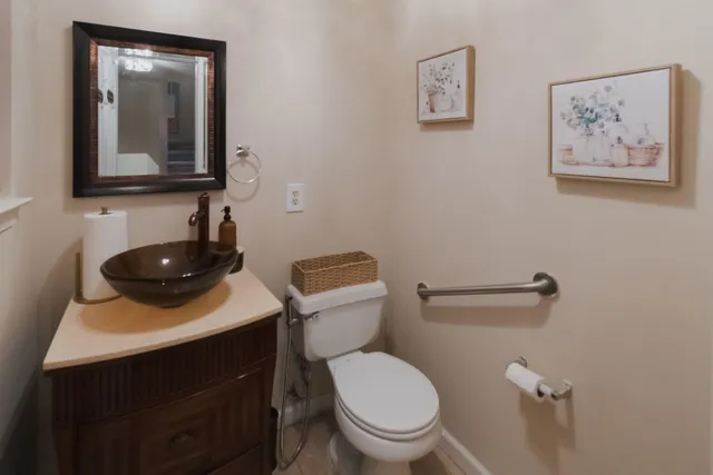 a bathroom with a toilet a sink and mirror