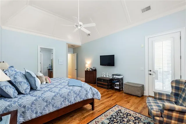 a bedroom with a large bed and a tv on the dresser