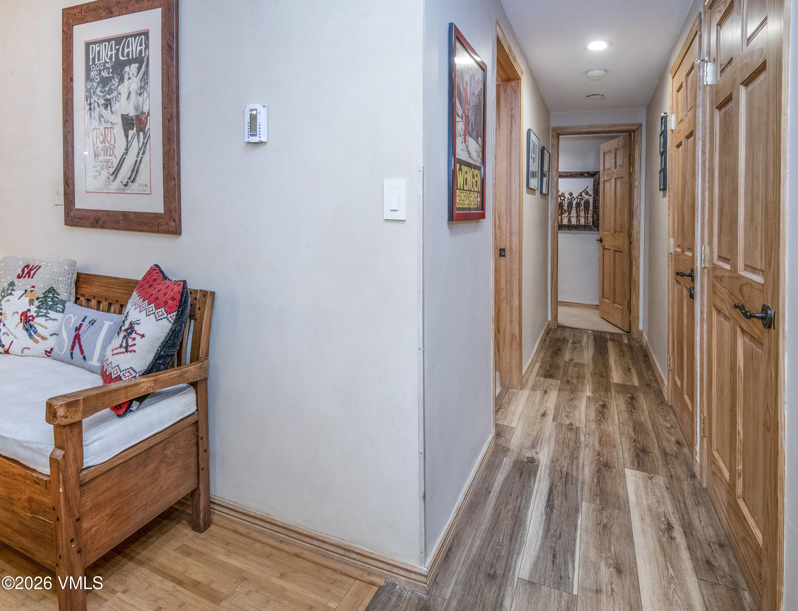 1650 Fall Ridge Road, Unit 202 Vail, CO 81657 - Photo 9 of 32 a view of a hallway with wooden floor and a bathroom