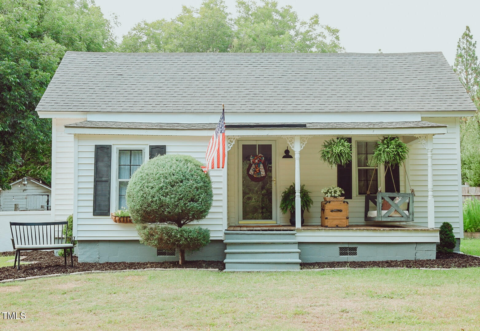 a front view of a house with a garden