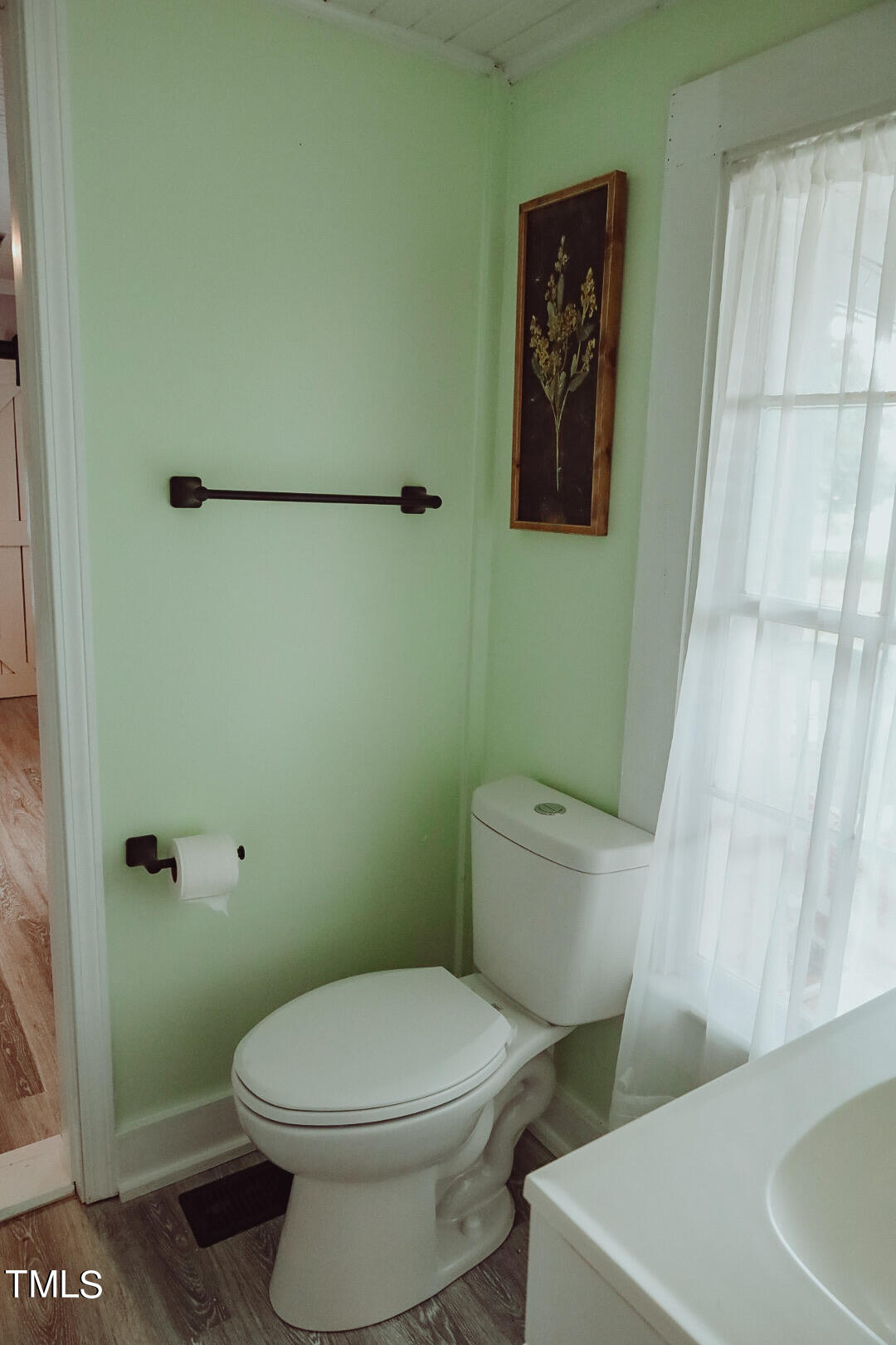 7105 Great Swamp Loop Lucama, NC 27851 - Photo 23 of 65 a white toilet sitting next to a white sink and vanity