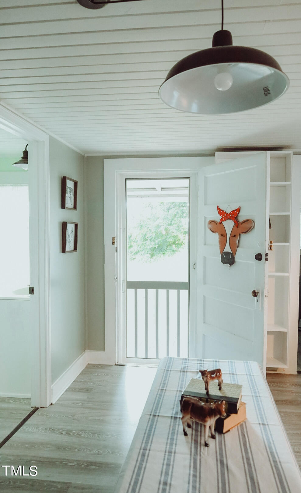 7105 Great Swamp Loop Lucama, NC 27851 - Photo 38 of 65 a hallway with a chandelier and wooden floor