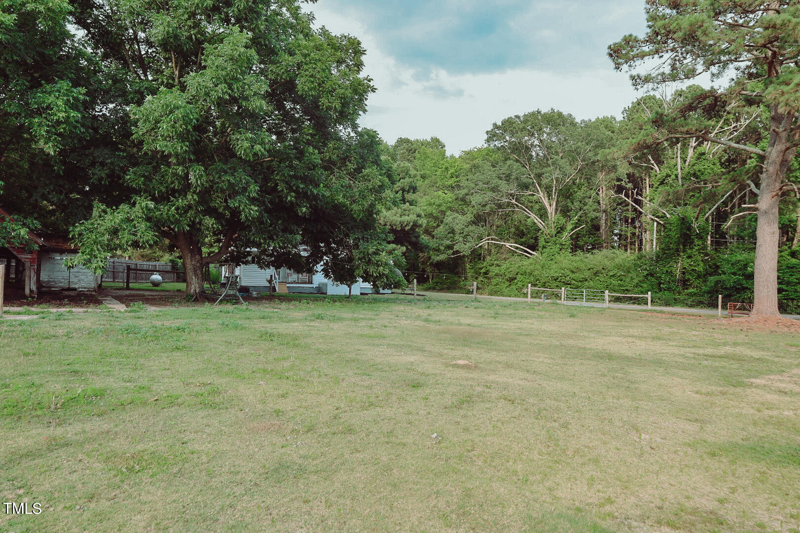 7105 Great Swamp Loop Lucama, NC 27851 - Photo 52 of 65 a view of outdoor space with deck and trees