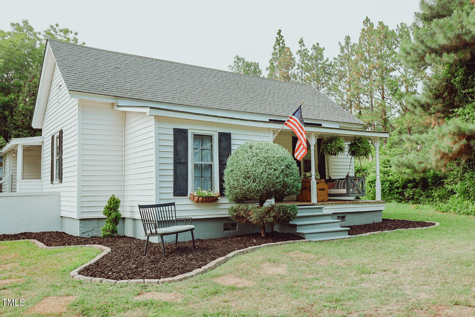 7105 Great Swamp Loop Lucama, NC 27851 - Photo 6 of 65 a front view of a house with garden