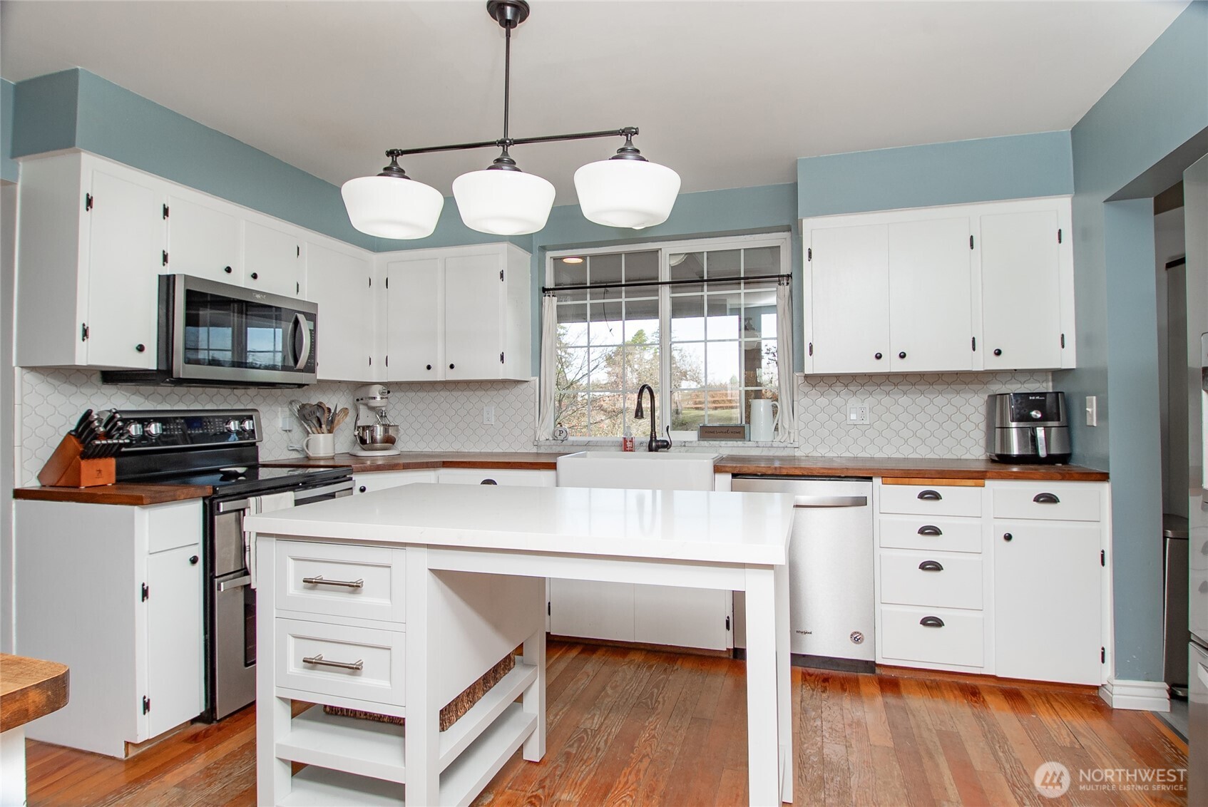 6084 Olson Road Ferndale, WA 98248 - Photo 12 of 40 a kitchen with stainless steel appliances a stove refrigerator sink and cabinets