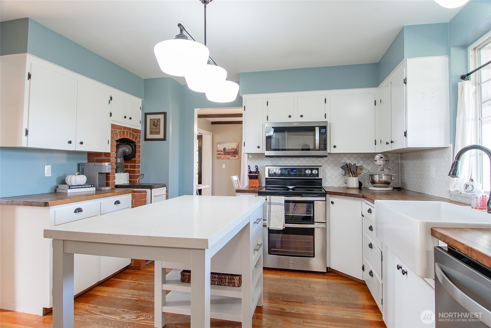 6084 Olson Road Ferndale, WA 98248 - Photo 13 of 40 a kitchen with stainless steel appliances a stove refrigerator sink and cabinets