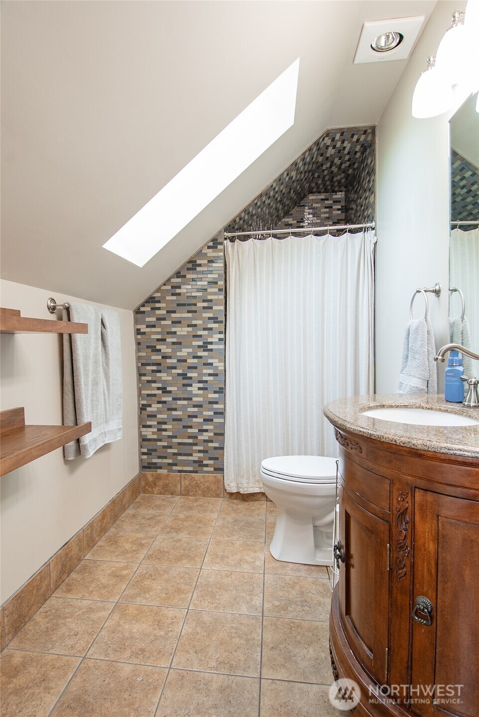 6084 Olson Road Ferndale, WA 98248 - Photo 26 of 40 a bathroom with a granite countertop sink a toilet and a tub