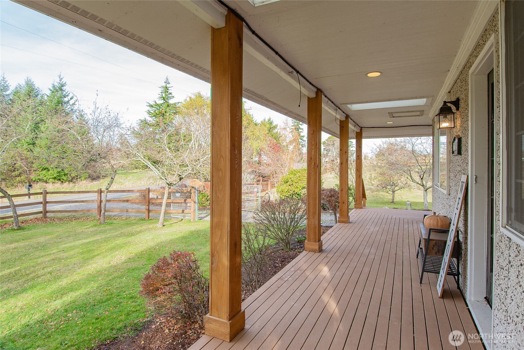 6084 Olson Road Ferndale, WA 98248 - Photo 40 of 40 a view of a living room and floor to ceiling window and wooden floor