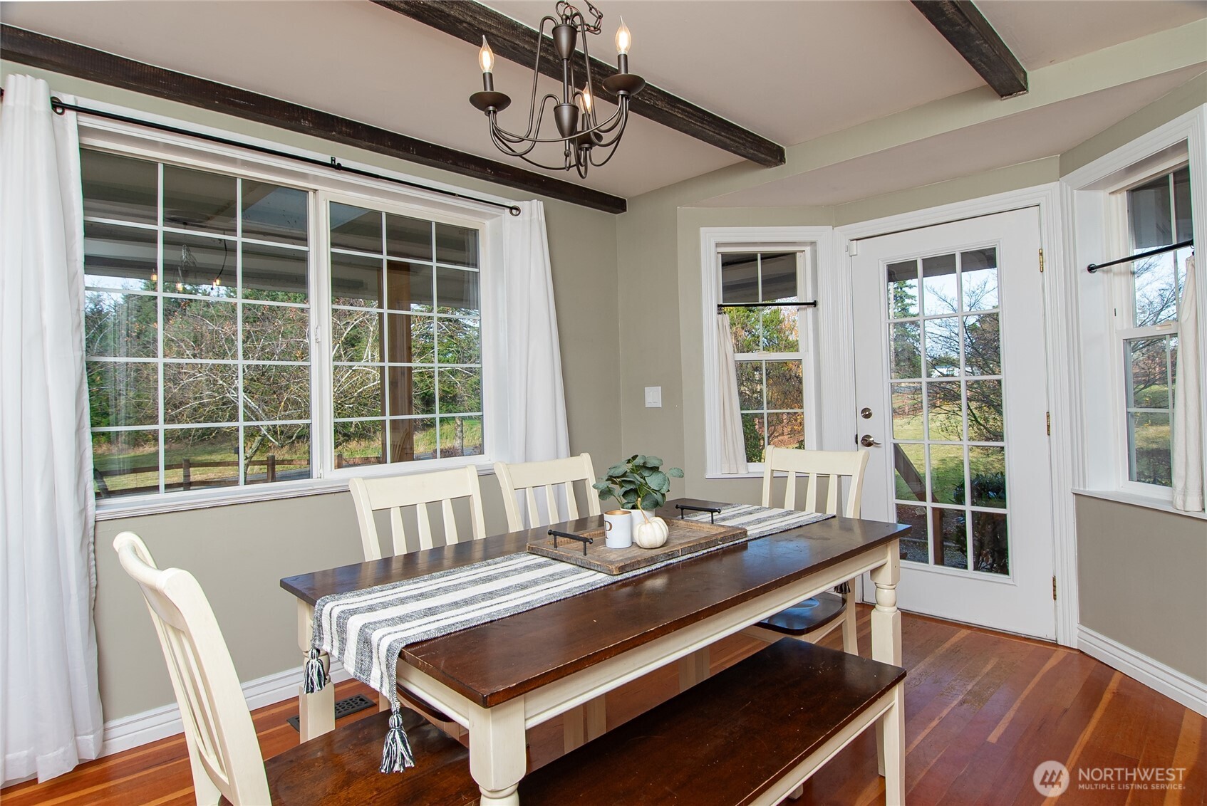 6084 Olson Road Ferndale, WA 98248 - Photo 10 of 40 a dining room with wooden floor and windows