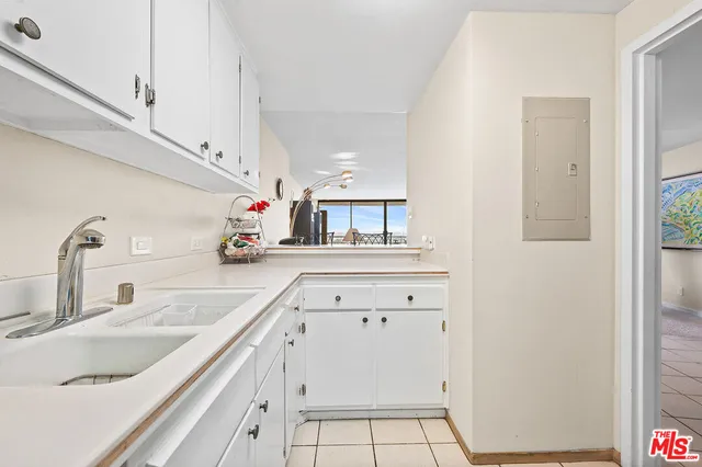 a kitchen with cabinets a sink and appliances