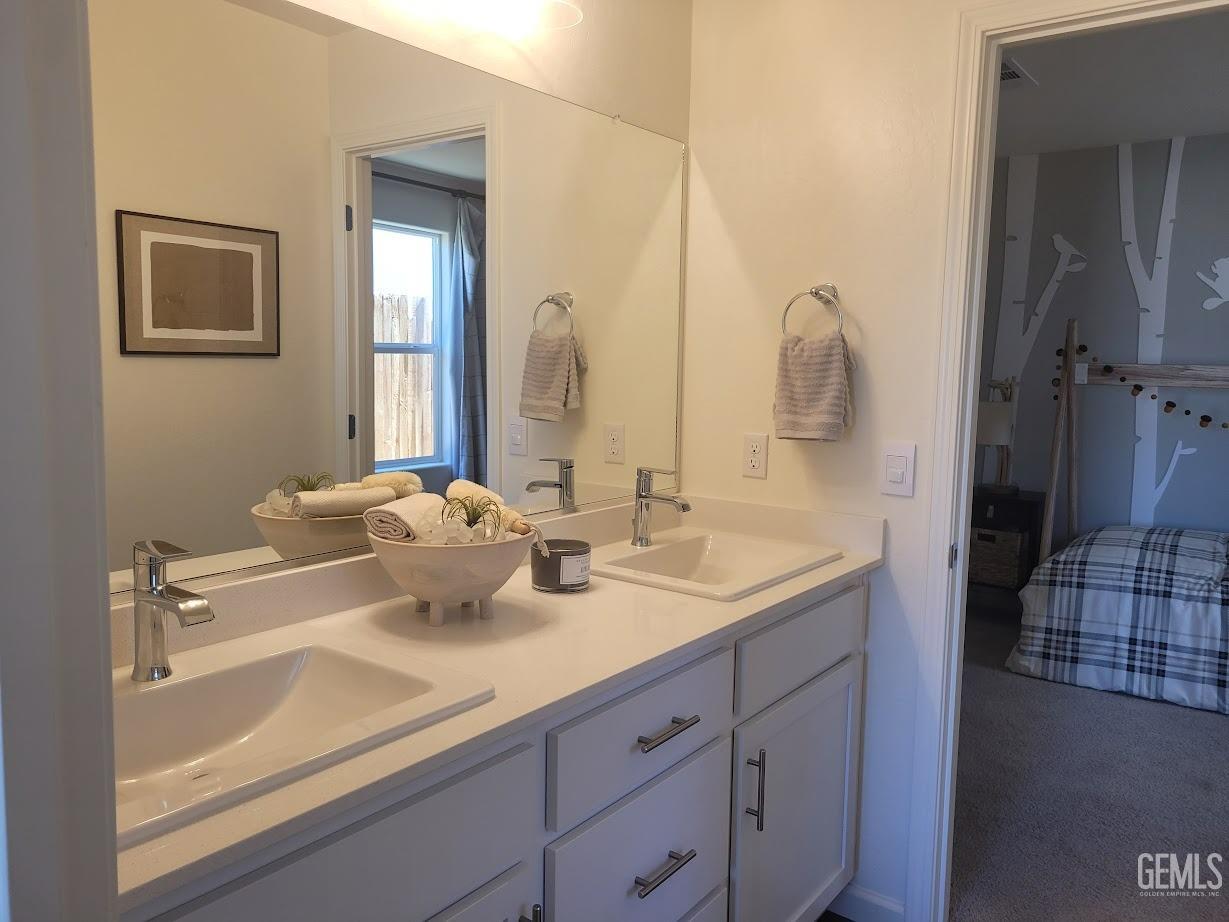 Undisclosed Address Bakersfield, CA 93307 - Photo 5 of 23 Jack-and-Jill bath with dual vanity sinks.