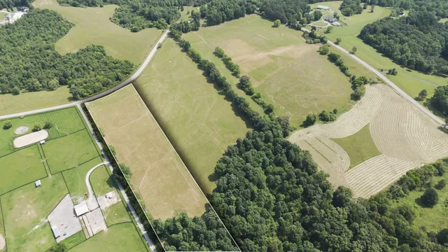 an aerial view of a house with a yard and swimming pool