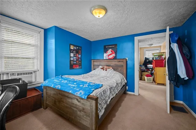 a bedroom with a bed and a couch