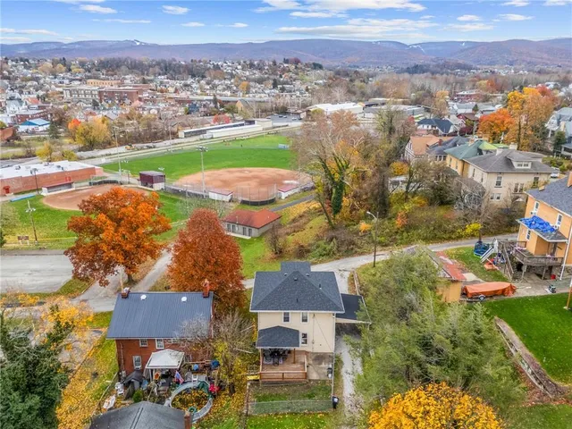 an aerial view of residential houses with outdoor space