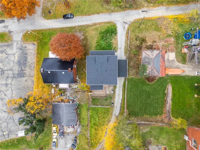 an aerial view of a house with yard swimming pool and outdoor seating