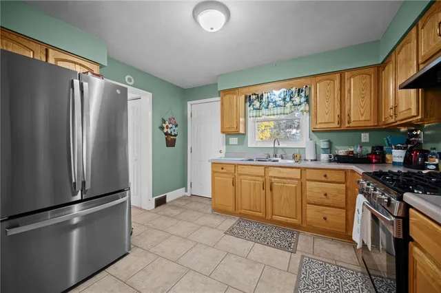 a kitchen with stainless steel appliances granite countertop a refrigerator sink and cabinets