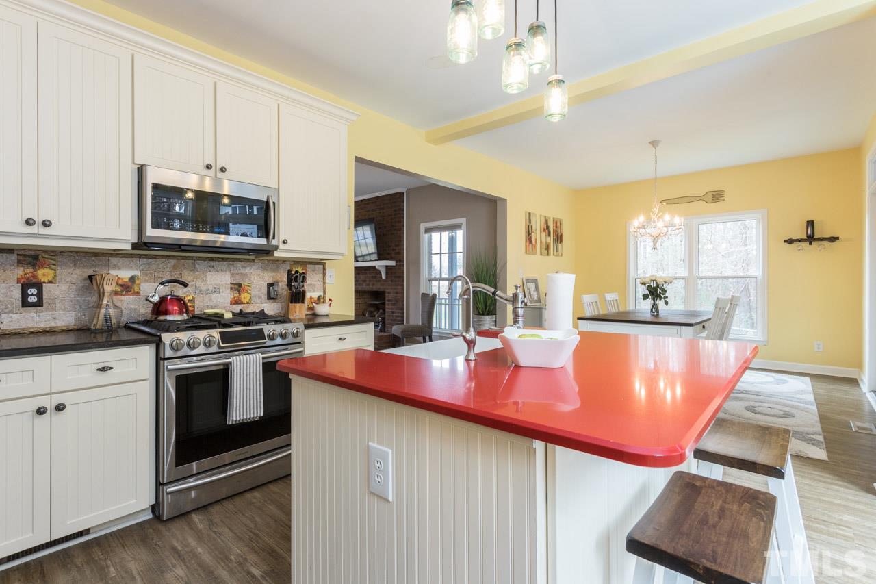 7505 Penny Road Raleigh, NC 27606 - Photo 15 of 25 a kitchen with stainless steel appliances granite countertop a sink and cabinets