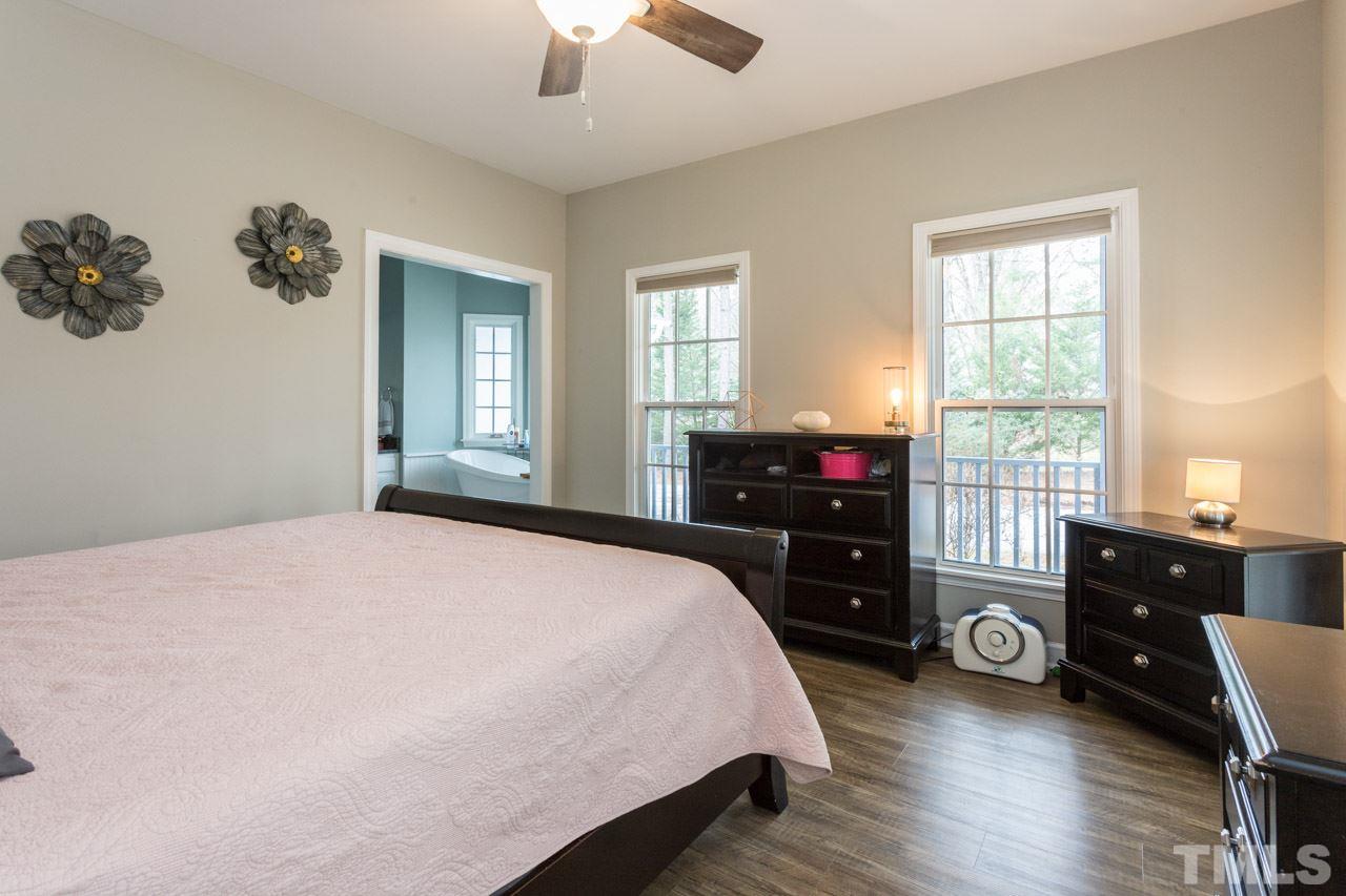 7505 Penny Road Raleigh, NC 27606 - Photo 18 of 25 a bedroom with a bed and a dresser