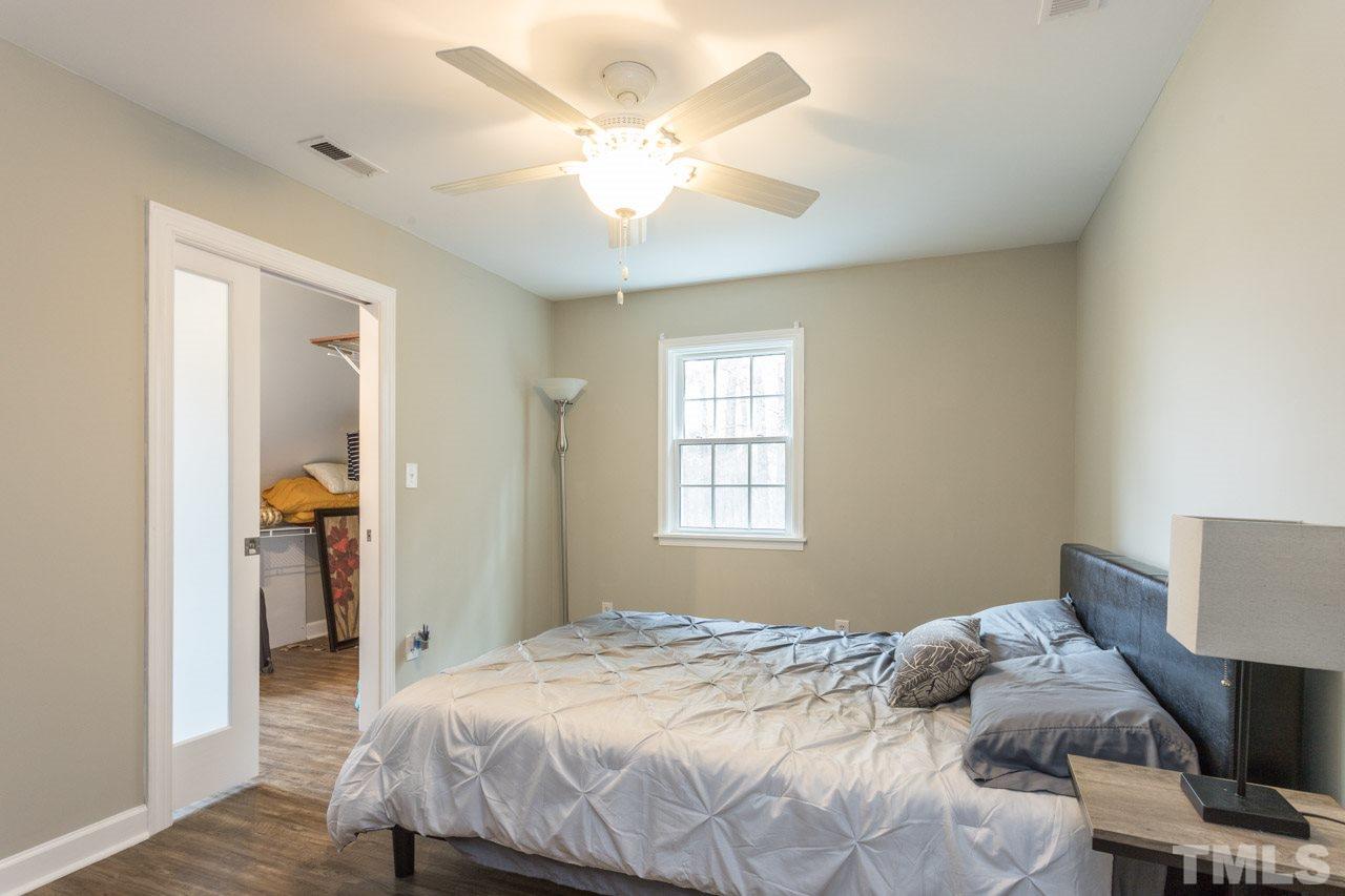 7505 Penny Road Raleigh, NC 27606 - Photo 21 of 25 a bedroom with a bed and a window