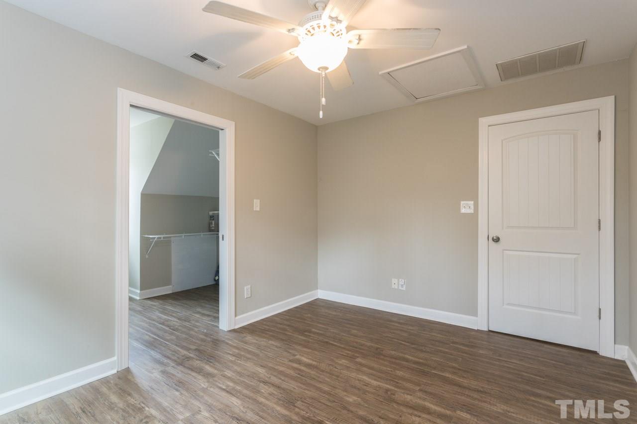 7505 Penny Road Raleigh, NC 27606 - Photo 24 of 25 a view of an empty room with wooden floor