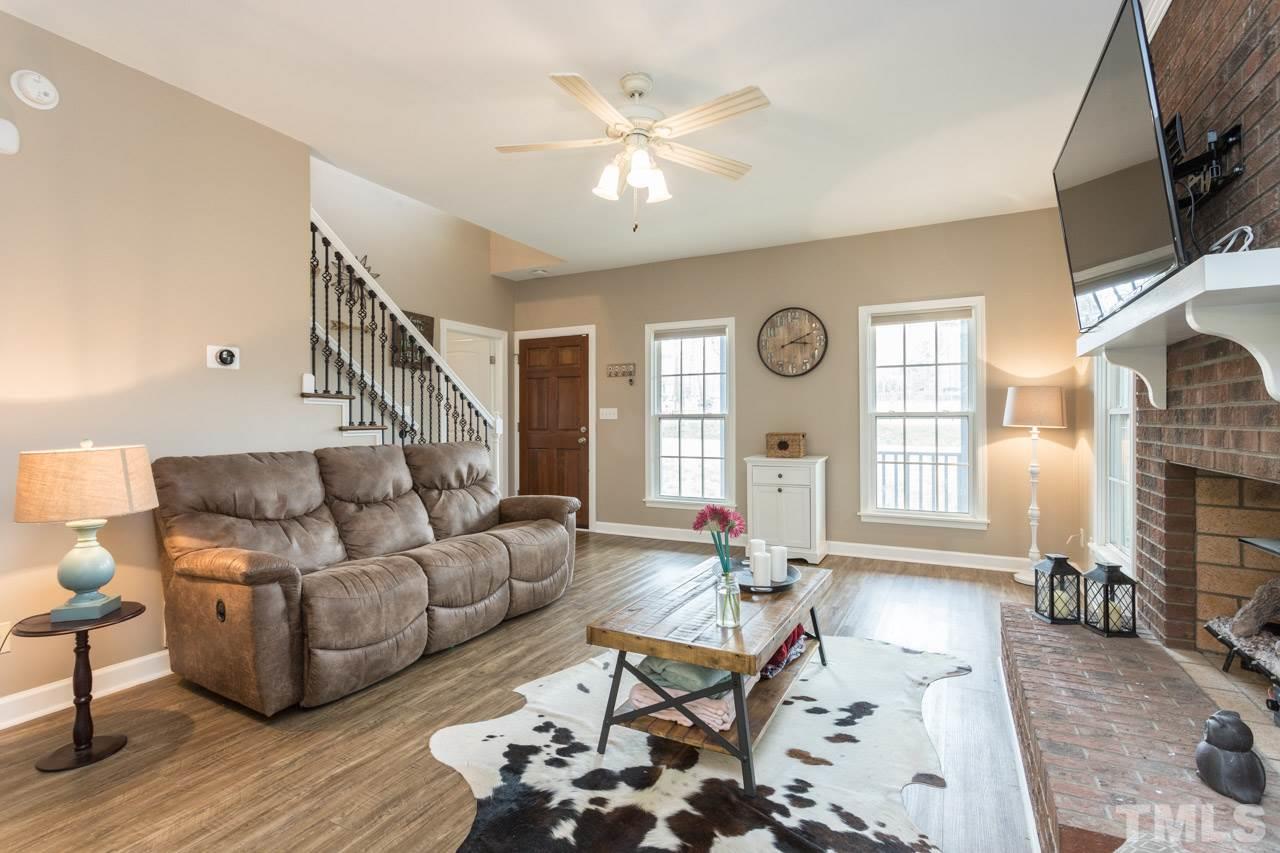 7505 Penny Road Raleigh, NC 27606 - Photo 8 of 25 a living room with furniture and a large window