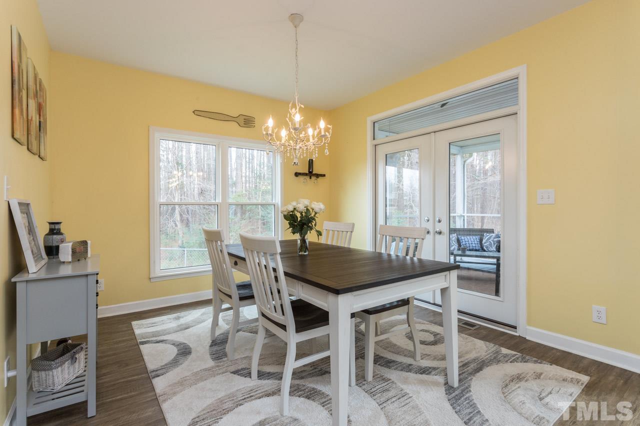 7505 Penny Road Raleigh, NC 27606 - Photo 10 of 25 a view of a dining room with furniture and chandelier