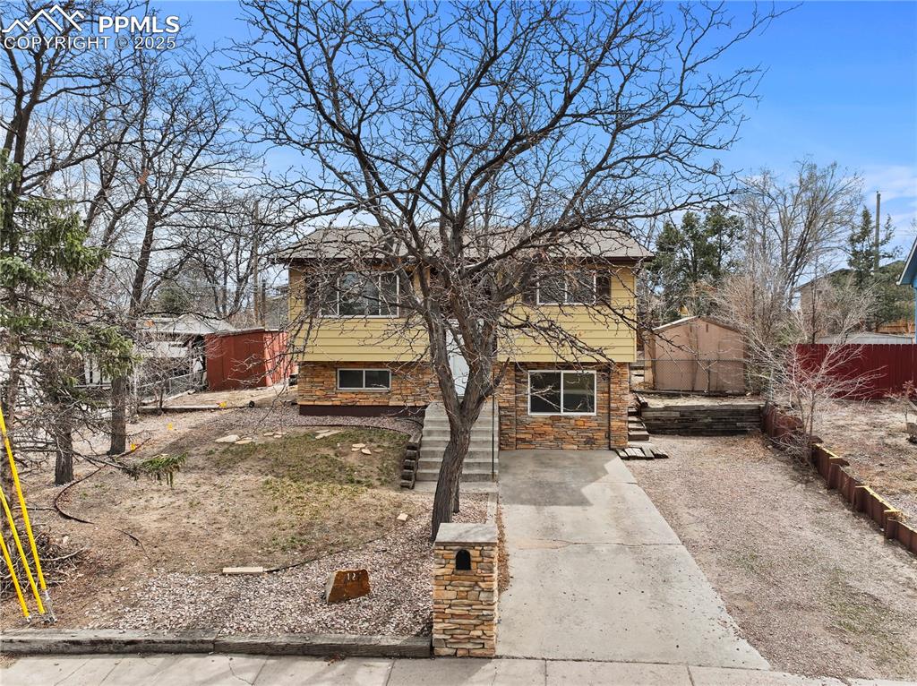4127 Bent Drive Colorado Springs, CO 80909 - Photo 32 of 41 a view of a house with a yard