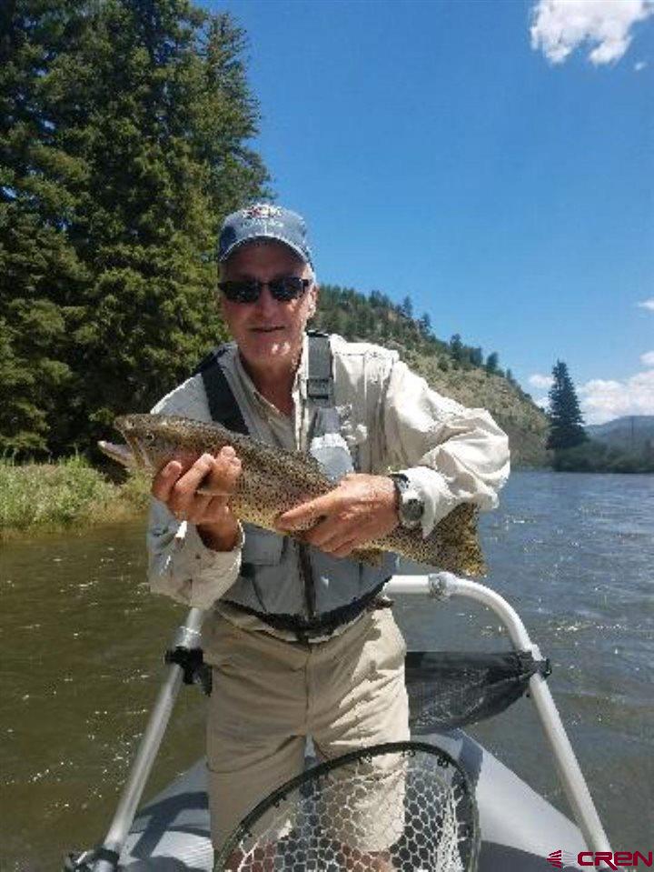 132 West Riverside Court South Fork, CO 81154 - Photo 6 of 6 a backyard of a house with table and chairs
