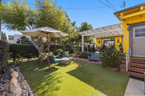 a bedroom with a large bed and a wooden floor