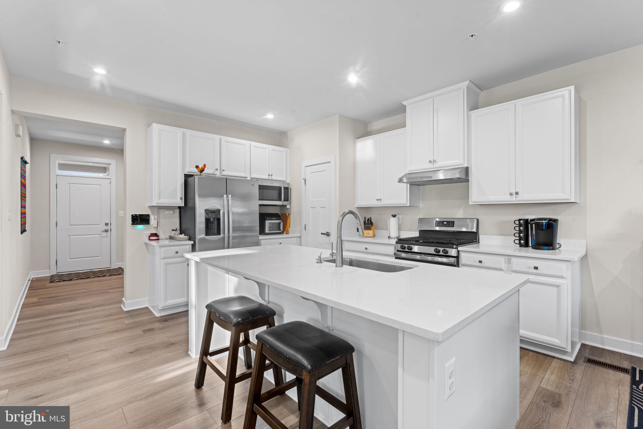 8003 Trimbles Ford Lane Brandywine, MD 20613 - Photo 11 of 70 a kitchen with white cabinets and white appliances
