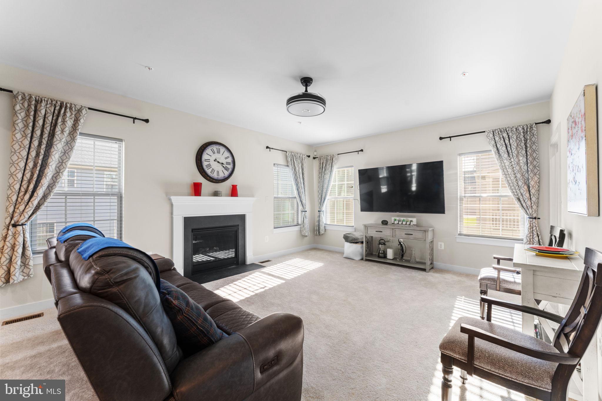 8003 Trimbles Ford Lane Brandywine, MD 20613 - Photo 17 of 70 a living room with furniture a flat screen tv and a fireplace