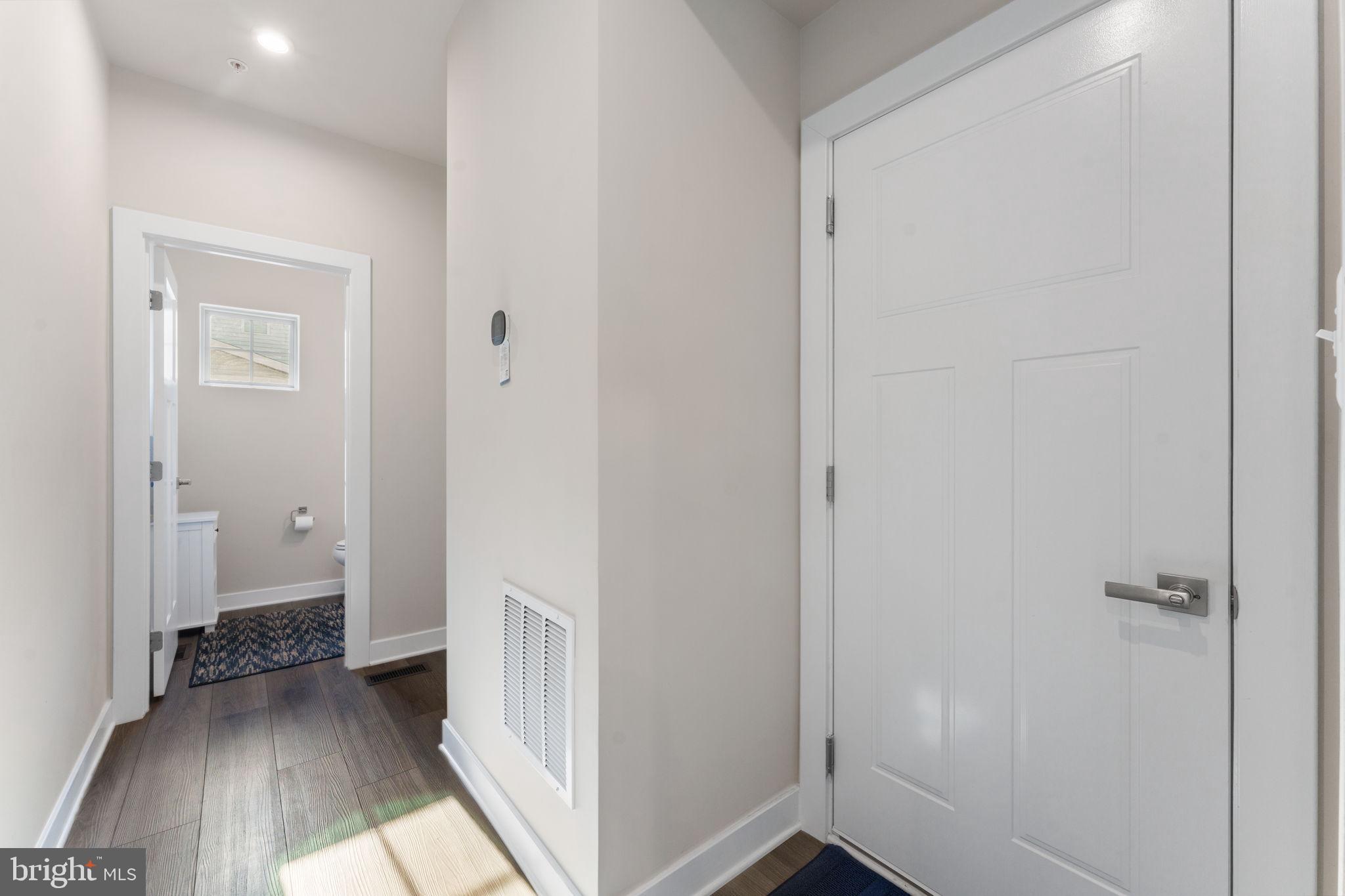 8003 Trimbles Ford Lane Brandywine, MD 20613 - Photo 22 of 70 a view of a hallway with wooden floor and a livingroom