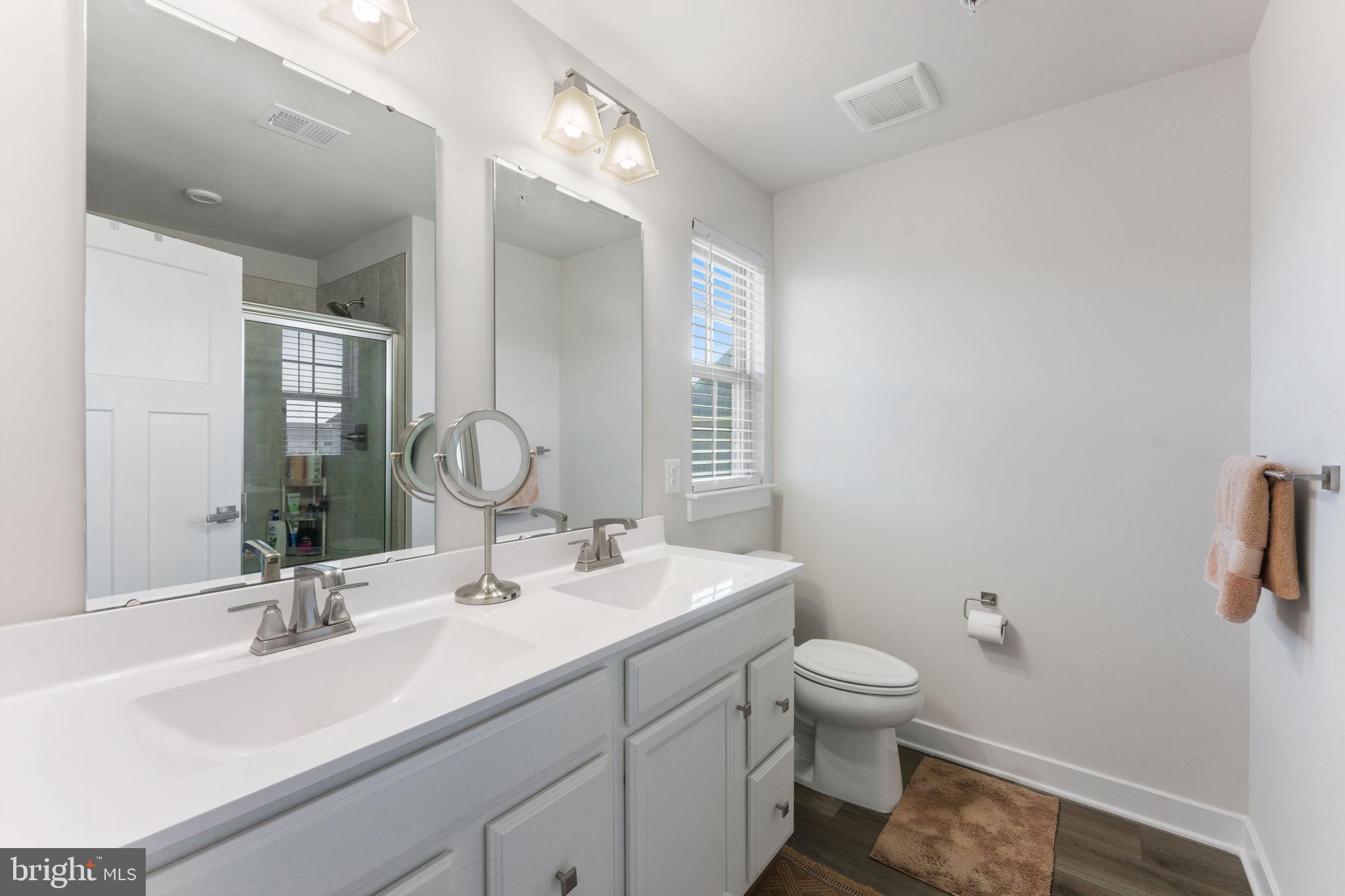 8003 Trimbles Ford Lane Brandywine, MD 20613 - Photo 36 of 70 a bathroom with a double vanity sink toilet and a mirror