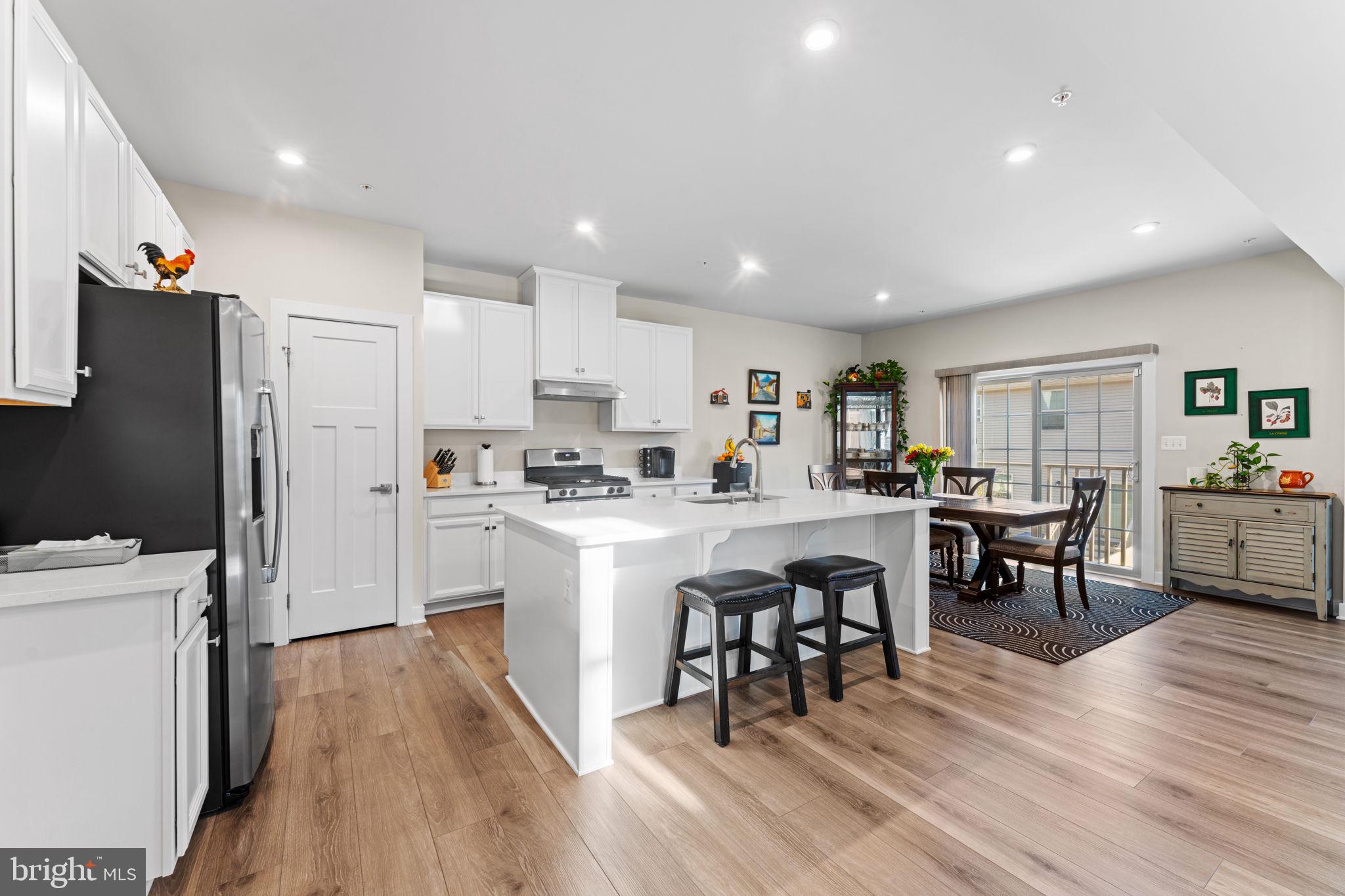 8003 Trimbles Ford Lane Brandywine, MD 20613 - Photo 10 of 70 a kitchen with white cabinets and stainless steel appliances