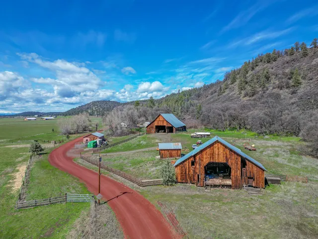 a bathroom with a double vanity sink toilet and shower