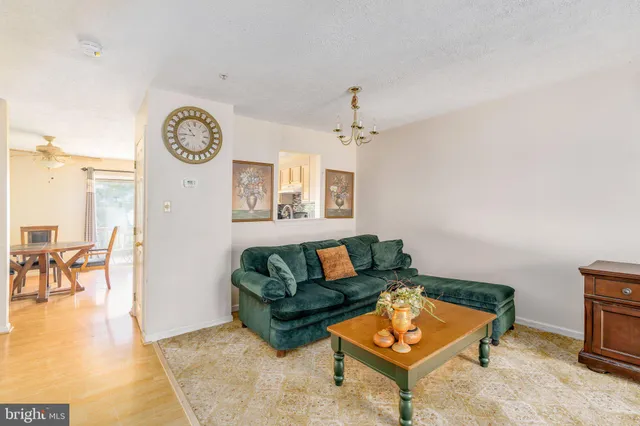 a living room with furniture and a wall painting