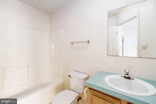 a bathroom with a sink toilet a mirror and shower