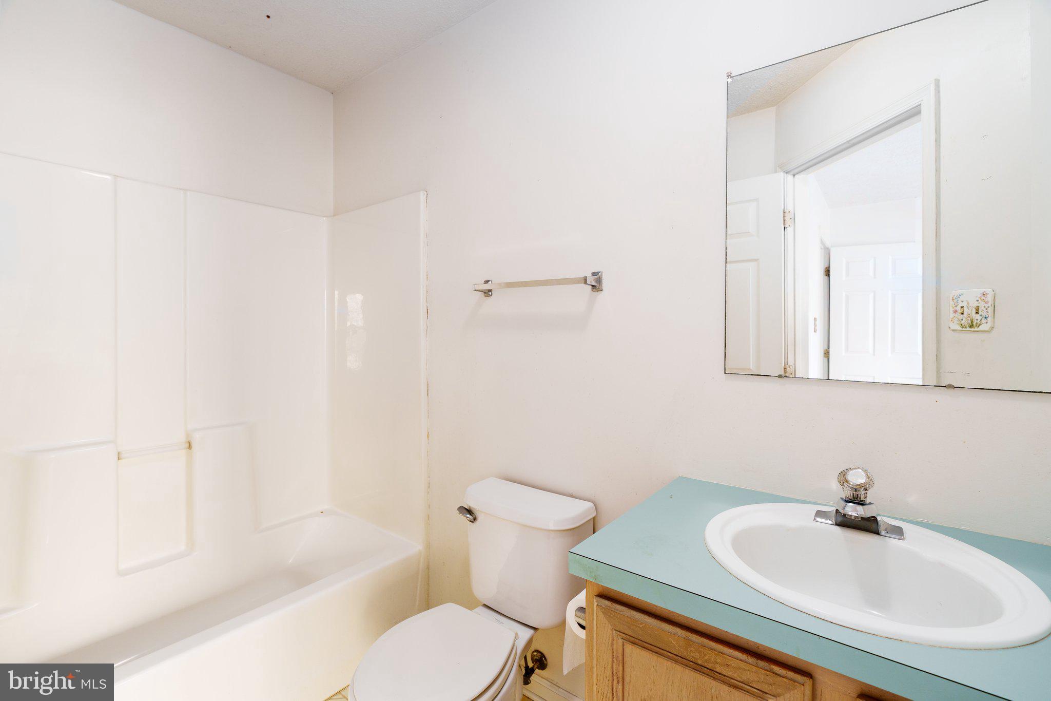 22 Buttonbush Court Elkton, MD 21921 - Photo 9 of 13 a bathroom with a sink toilet a mirror and shower