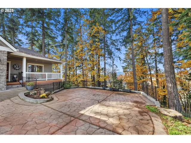 a backyard of a house with garden and outdoor seating