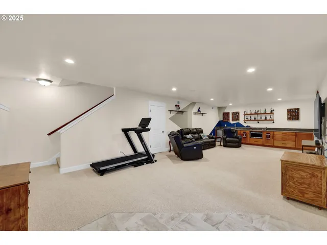 a living room with furniture a flat screen tv and a table