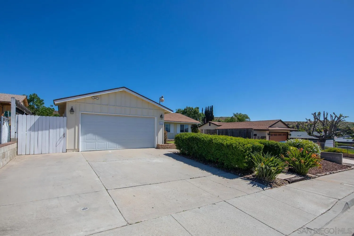 9460 Lake Canyon Road Santee, CA 92071 - Photo 3 of 46 a view of a house with a yard and potted plants