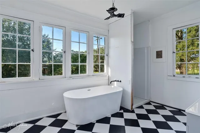 a white bath tub sitting next to a window