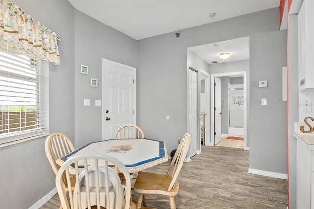 a view of a dining room with furniture and wooden floor