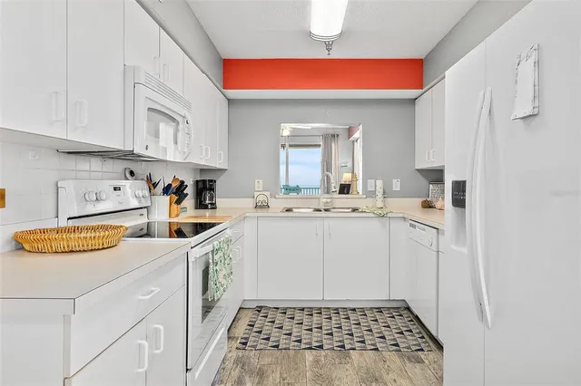 a kitchen with stainless steel appliances granite countertop a sink and cabinets