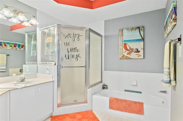 a bathroom with a tub sink and mirror