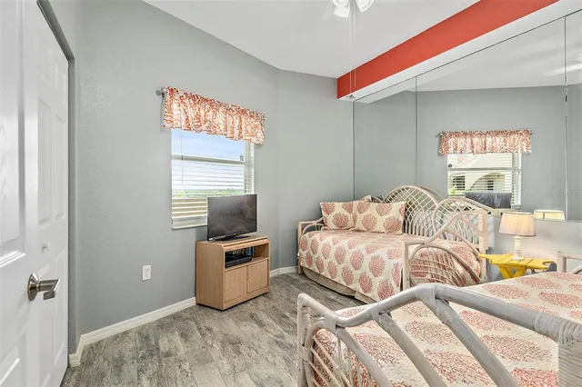 a bedroom with two beds and a window