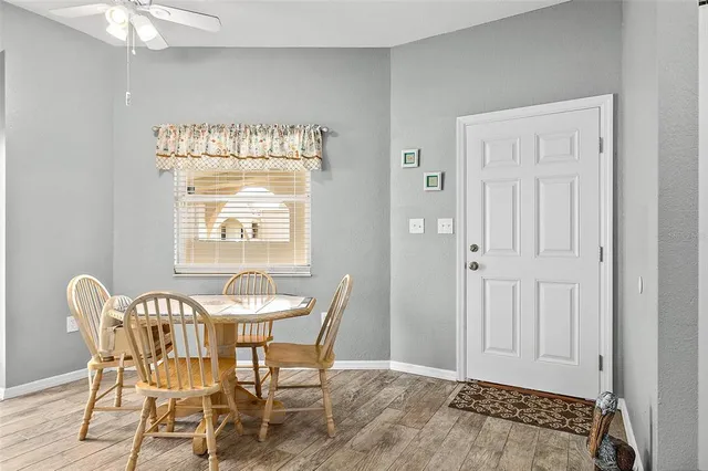 a view of a dining room with furniture and window