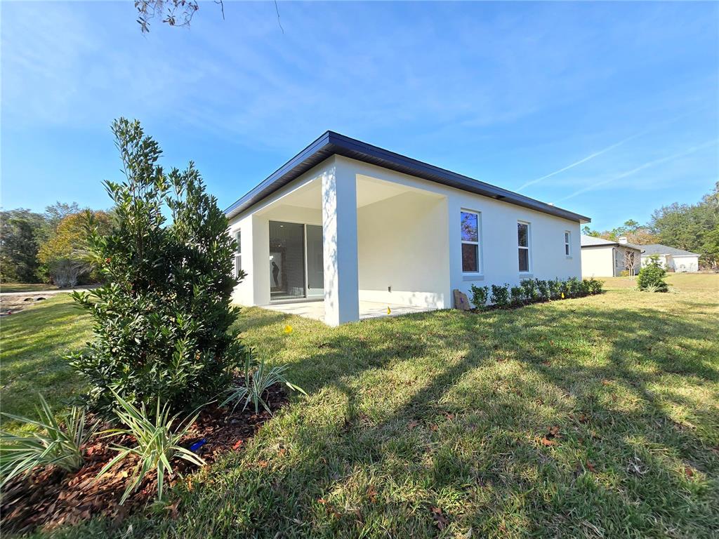 6 Calendula Court Homosassa, FL 34446 - Photo 32 of 67 a view of an house with backyard space and garden